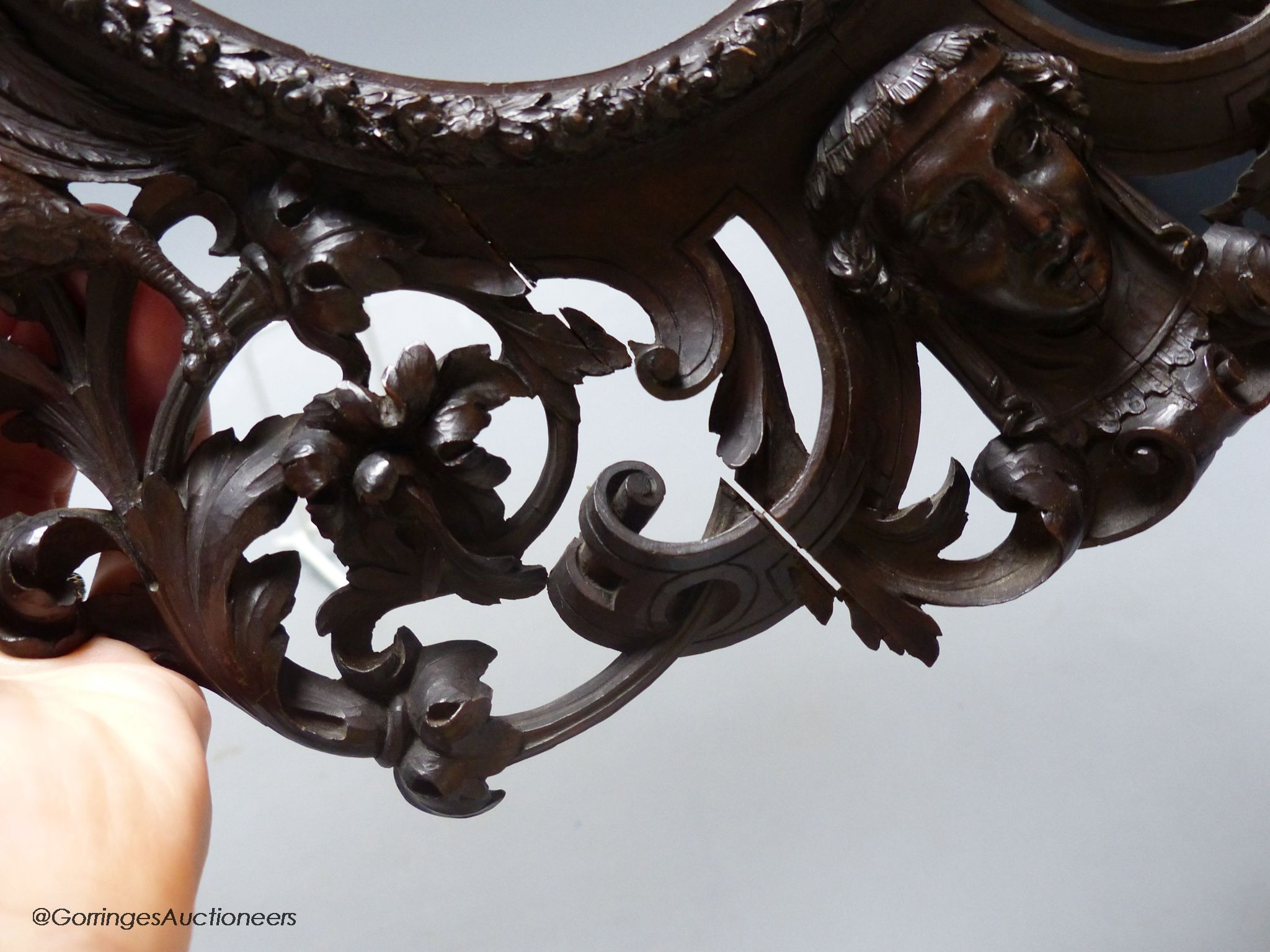 An 18th century Italian carved walnut oval picture frame